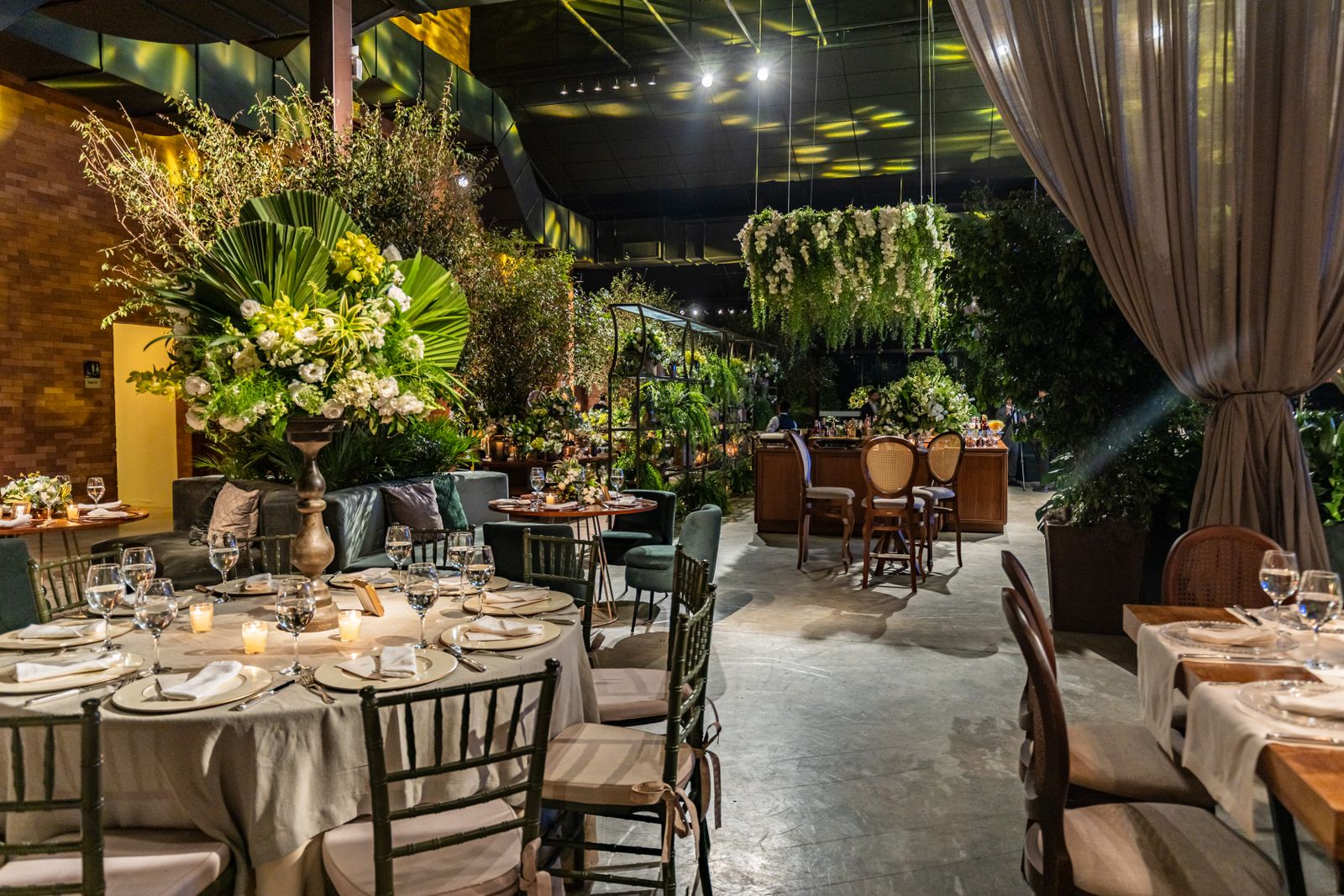Banquet tables with floral arrangements in a modern venue